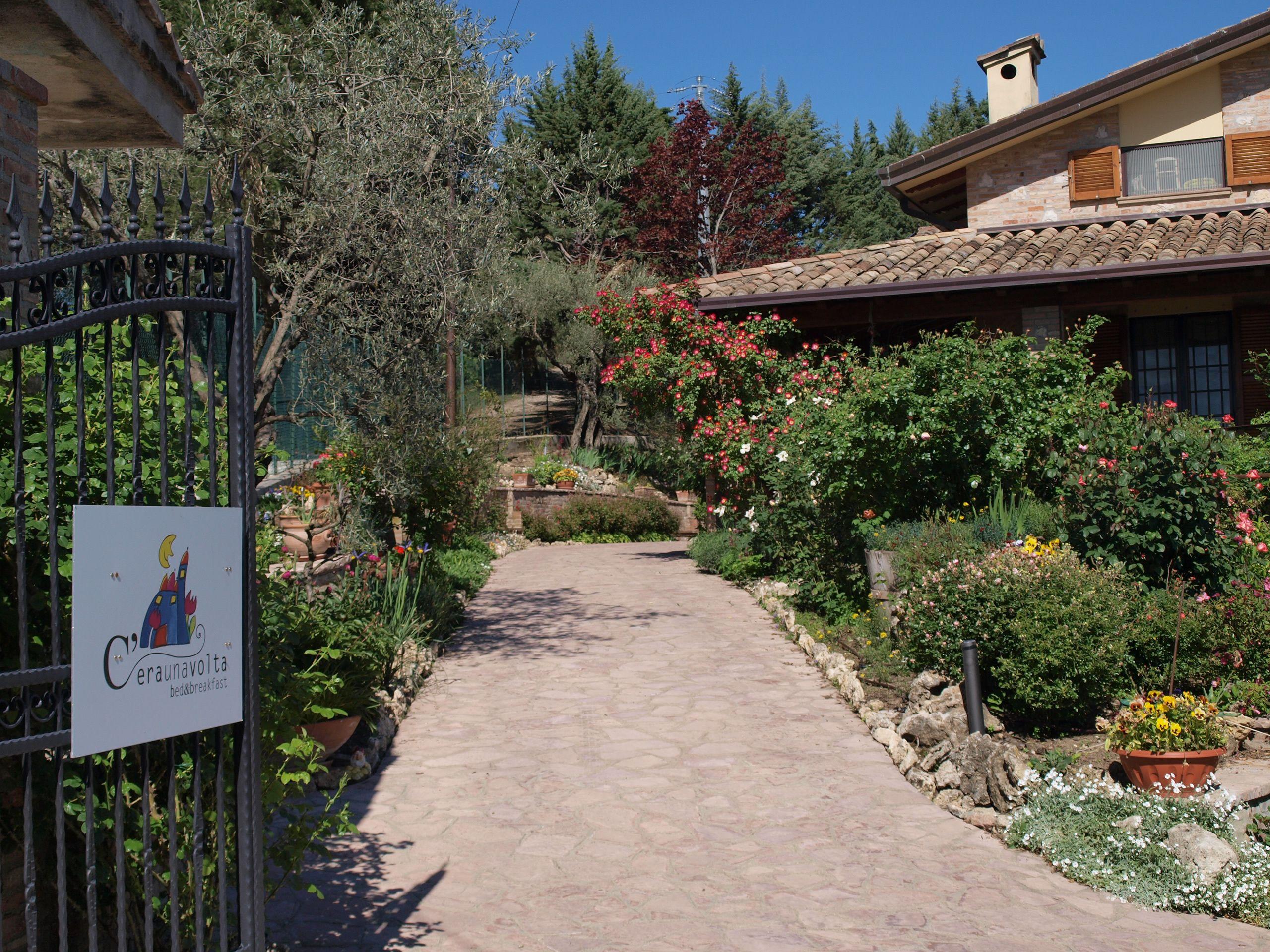 A warm welcome at the main entrance path leading through the green garden.