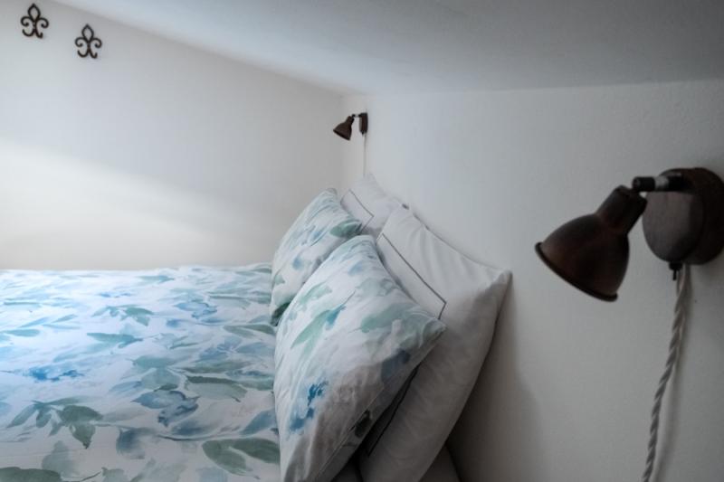 Elegant antique wooden wardrobe and cozy double bed in the attic Orchidea Room. Elegant antique wooden wardrobe and cozy double bed in the attic Orchidea Room.
