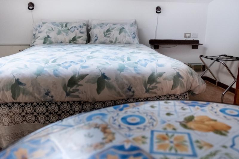 Elegant antique wooden wardrobe and cozy double bed in the attic Orchidea Room. Elegant antique wooden wardrobe and cozy double bed in the attic Orchidea Room.