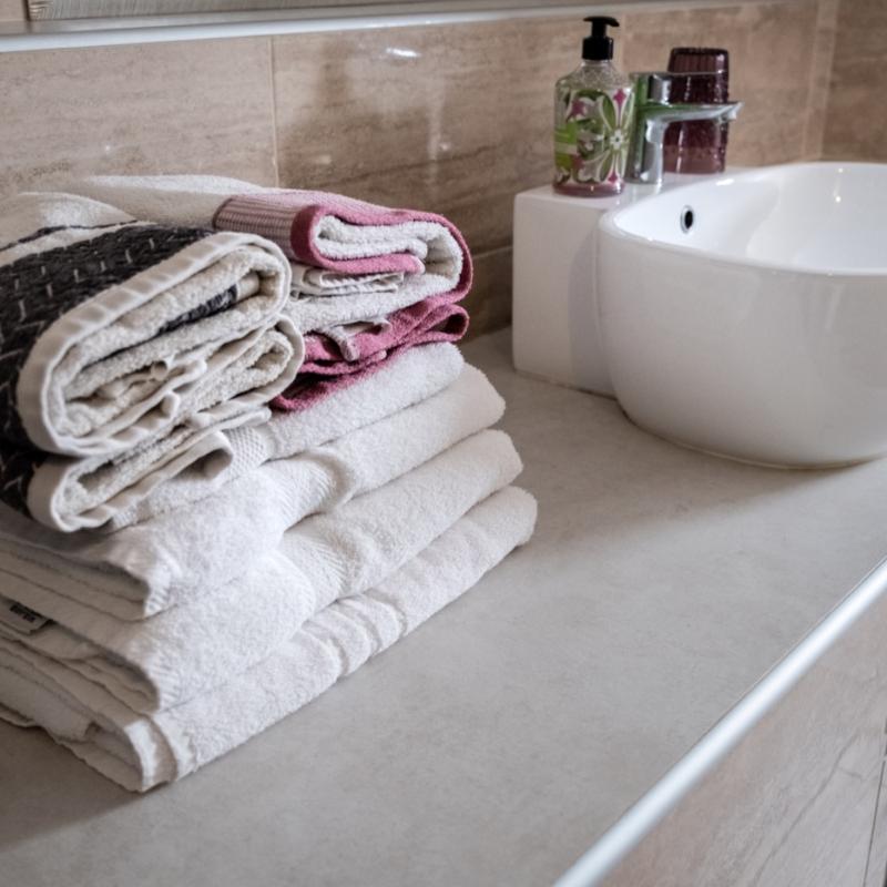 Modern bathroom equipped with a washing machine and dryer for your convenience